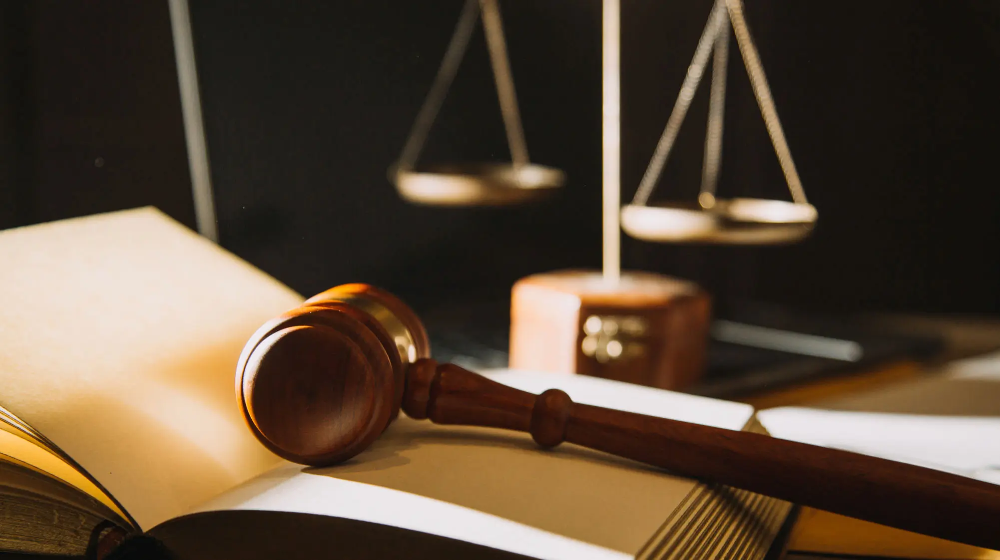 Drug-Possession-Attorney gavel on an open book with the scales of justice in the background