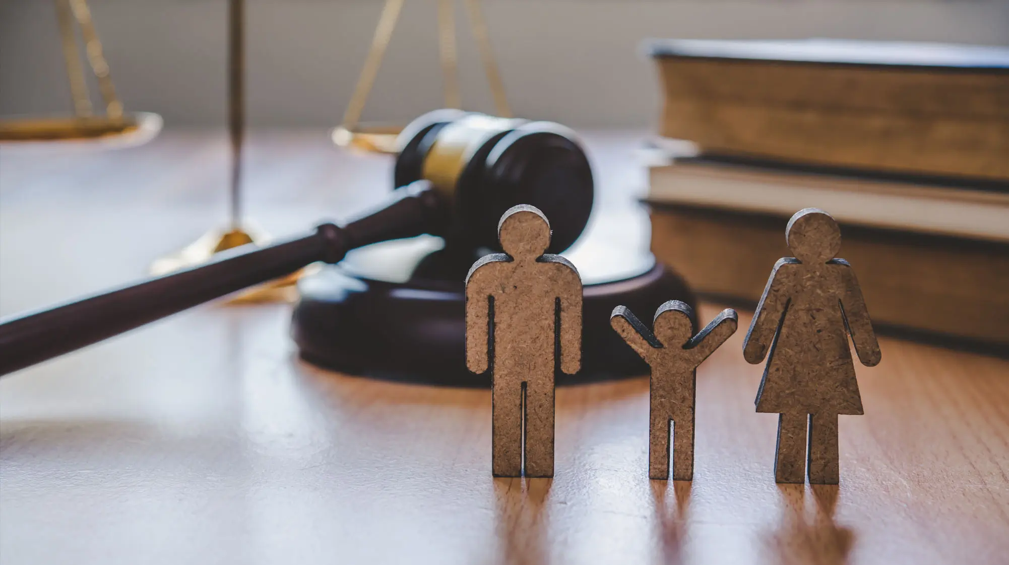 Family-Violence-Lawyer-2 scales of justice gavel law books and wooden family portraying family law in family violence case